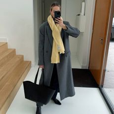 Anouk Yve in a yellow scarf and grey coat