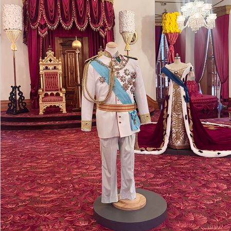 A gown and suit in the Iolani Palace throne room 