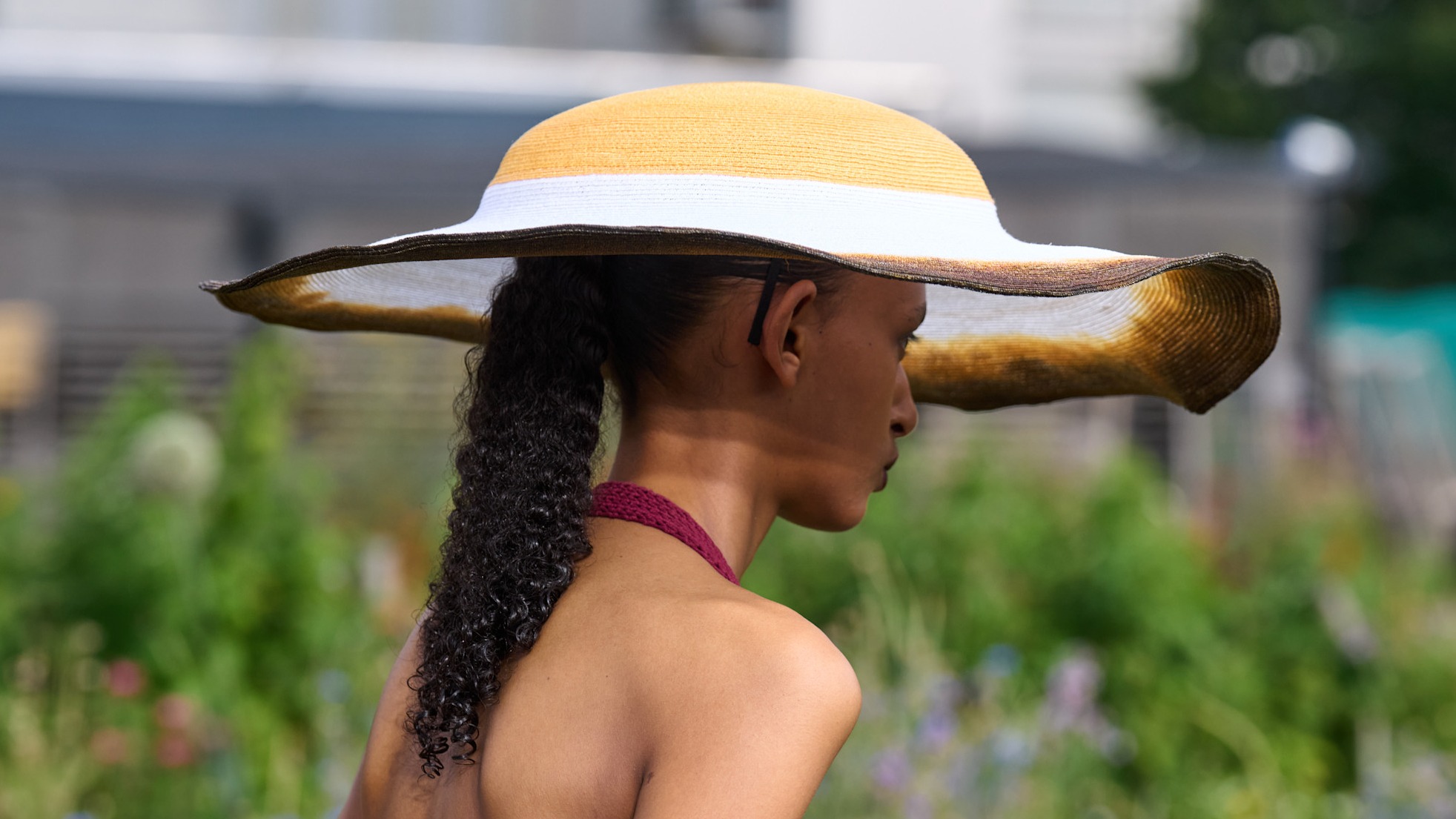 a woman walking with a hat