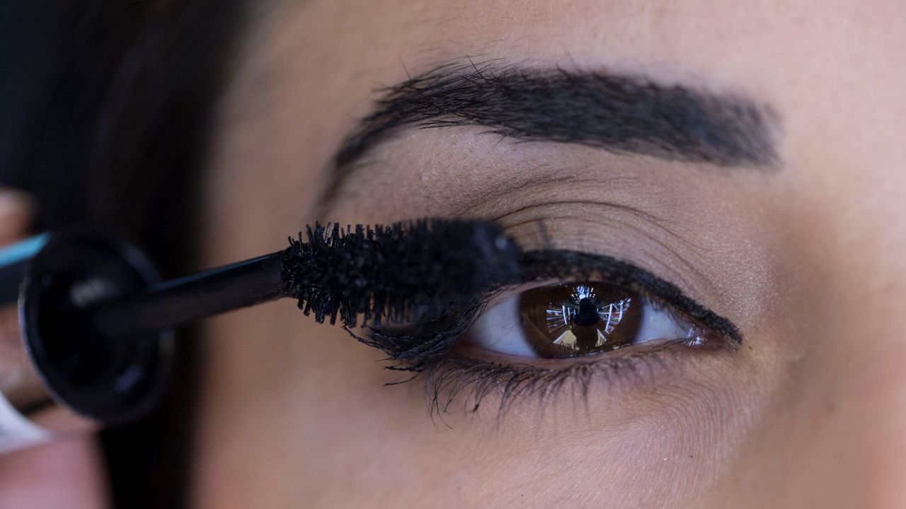 woman applying mascara