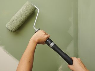 A Harris paint brush painting a wall green