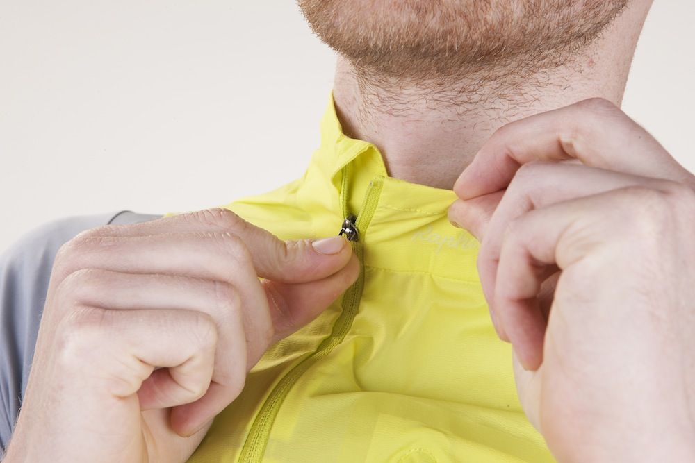 Man zipping up a yellow gilet