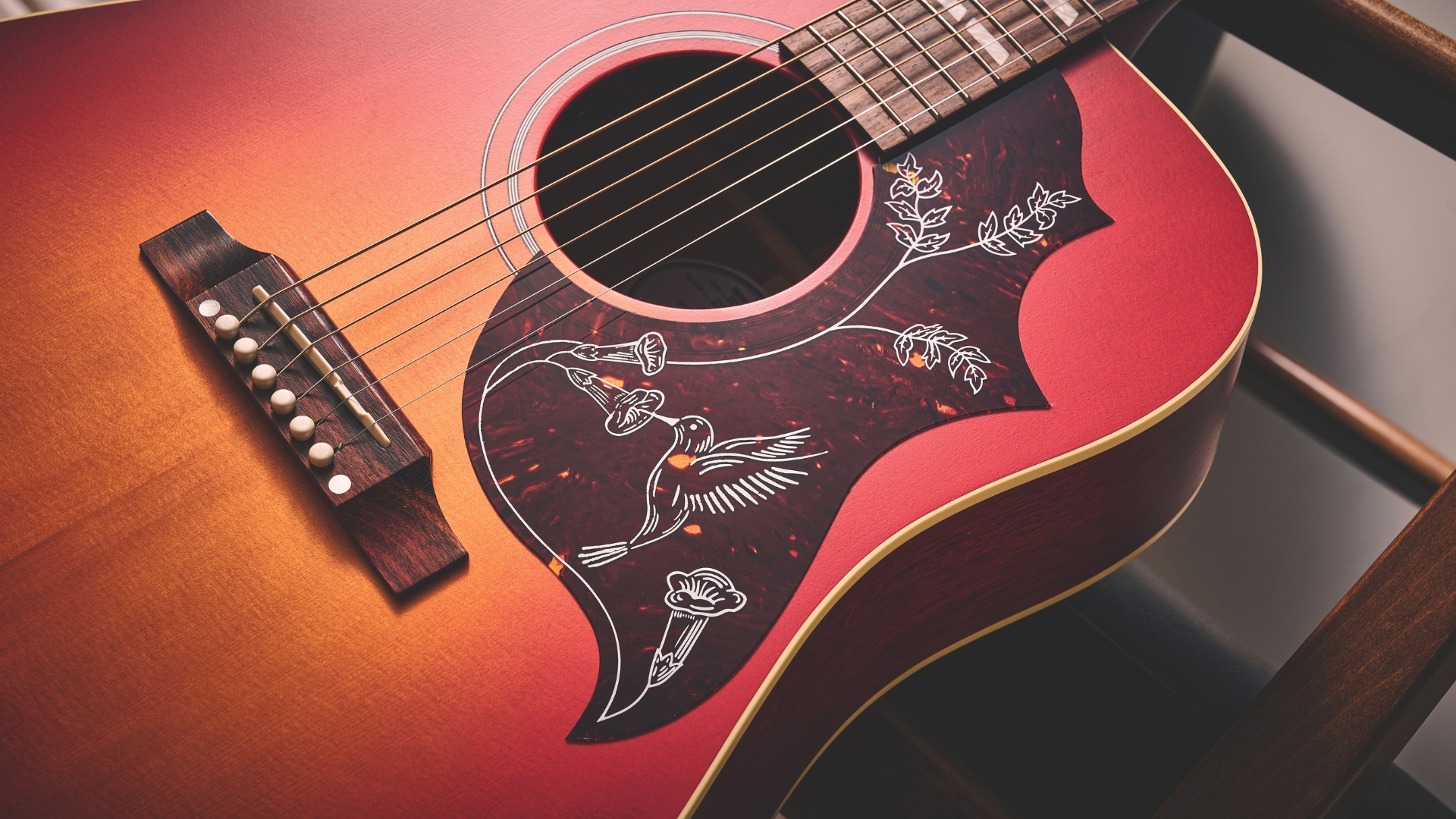 Close up of the pickguard on a Gibson Hummingbird acoustic guitar