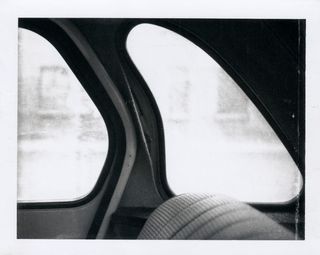 Detail of a black and white Polaroid by Robert Mapplethorpe of a car window in sunlight