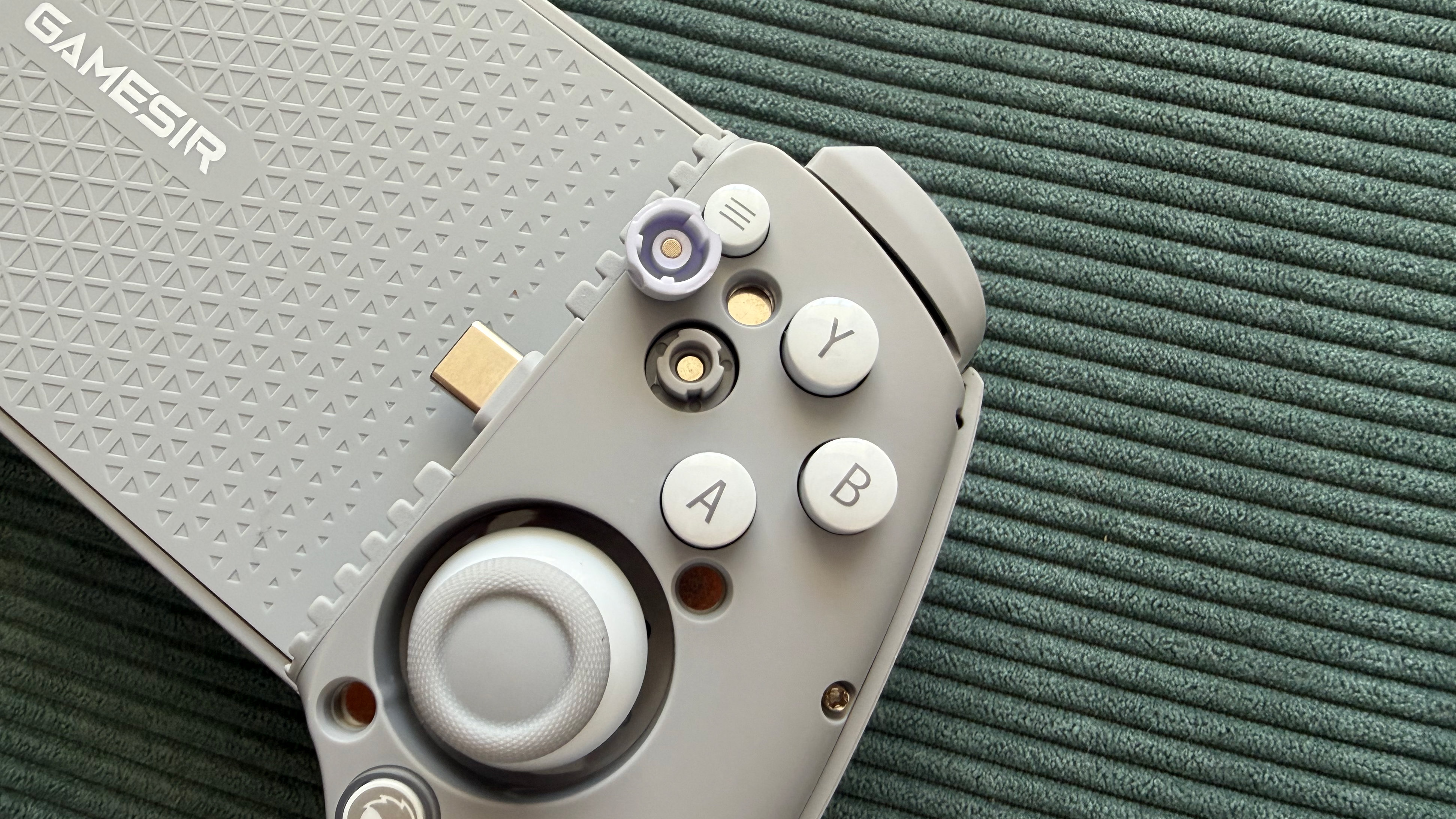 The GameSir G8+ MFi mobile controller on a green surface