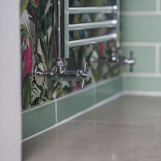 bathroom with banana leaf printed wallpapers and tiled flooring