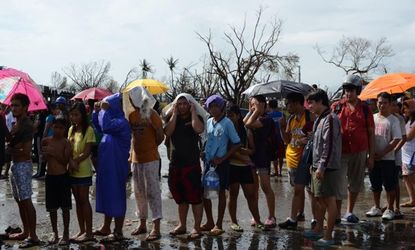 Affected residents wait in line for relief goods in Tacloban City, Philippines. Around 10,000 people are feared dead in Typhoon Haiyan, the strongest to hit the Philippines this year.