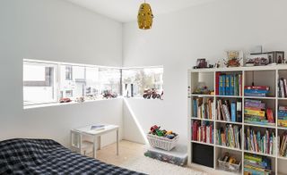 Childs bedroom with bookshelf and toys