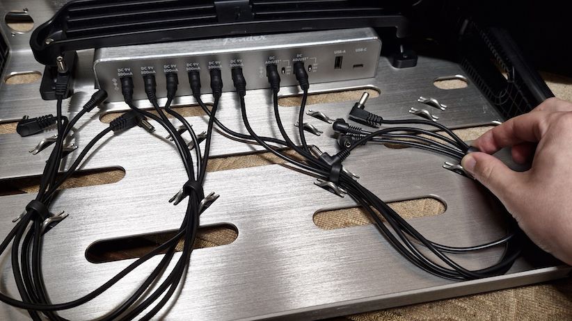 The underside of a Fender Professional Small pedalboard with a power supply mounted