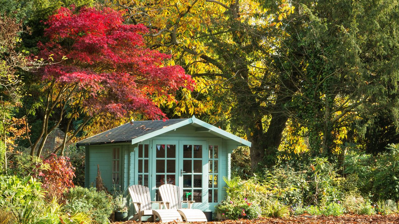 Summerhouse in garden surrounded by mature trees