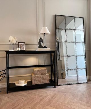 An antique glass mirror in Scandinavian-inspired hallway