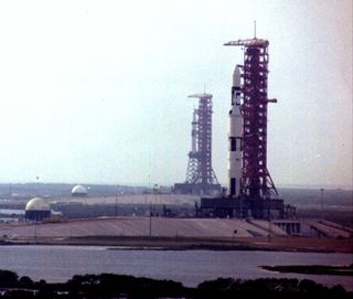 The Saturn V rocket carrying NASA's Skylab space station stands atop Launch Pad 39A at the Kennedy Space Center in Florida ahead of its launch in 1973. A Saturn IB rocket carrying an Apollo crew capsule for the first crewed Skylab mission is visible in the background on Pad 39B.