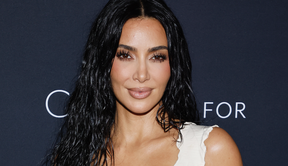 kim kardashian has glossy wet-look curls and a bronze makeup look