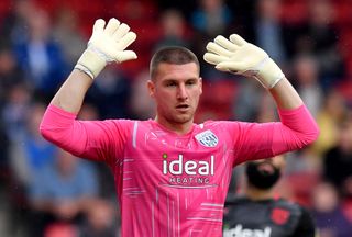 West Bromwich Albion goalkeeper Sam Johnstone gestures with both hands out to the side and above his head