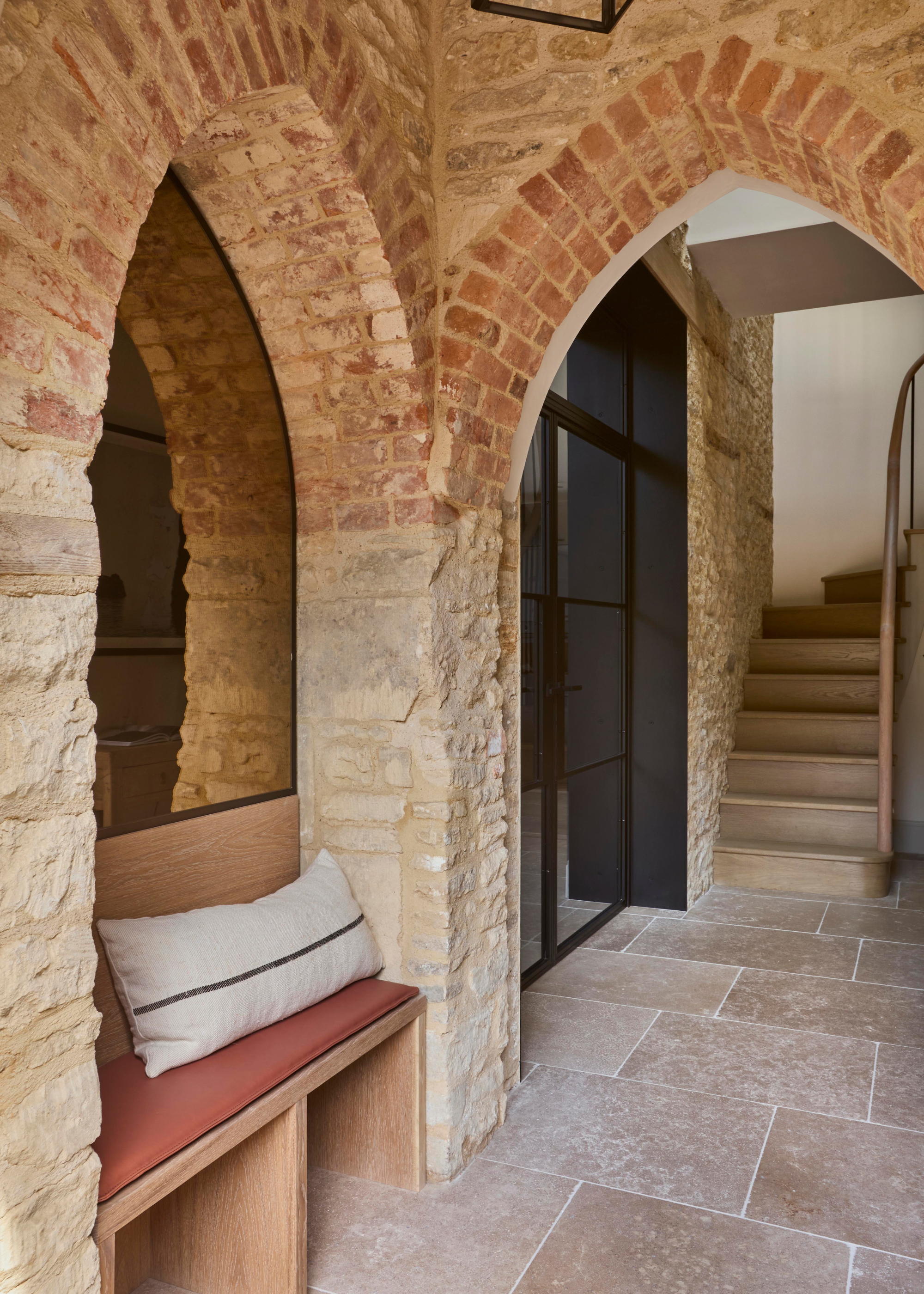 converted chapel entrance with exposed woodwork double ogival arches and a built in seating area