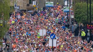 Mass group of runners pass the one mile mark during The TCS London Marathon on Sunday 23rd April 2023