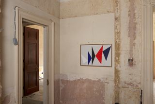 Painting featuring triangles in red and blue