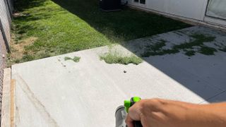removing grass from back patio with the Greenworks Pro 80v
