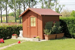 small brown shed in a garden