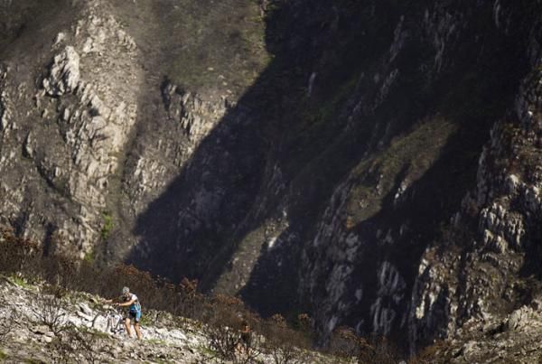 A rider pushes his bike during stage 4 of the Cape Epic