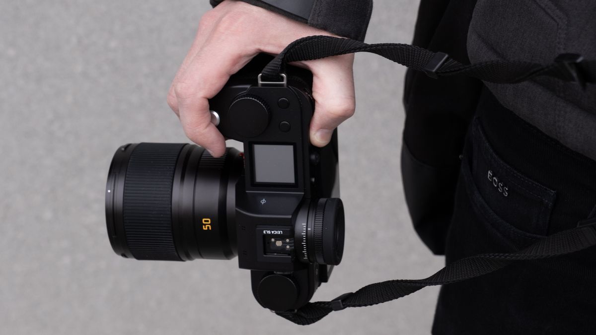 Hands holding the Leica SL3 camera