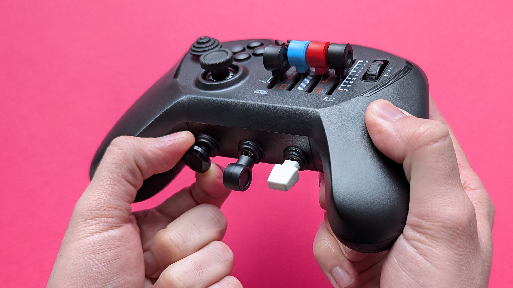 Honeycomb Aeronautical Echo Aviation Controller with a magenta cardstock background highlighting the parking brake