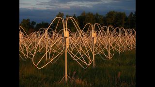 Rows of twisted metal in a grass field