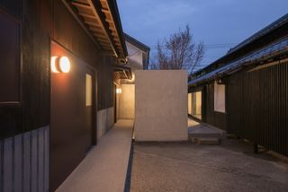 Exterior at dusk with lights on at the Yamaguchi Sake Brewery based in Kurume city