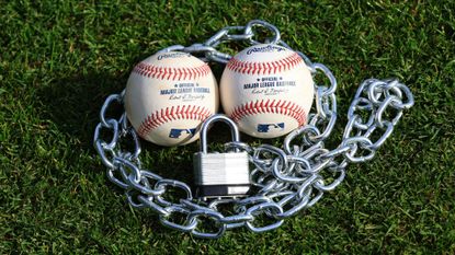 An image of baseballs surrounded by a padlock. 