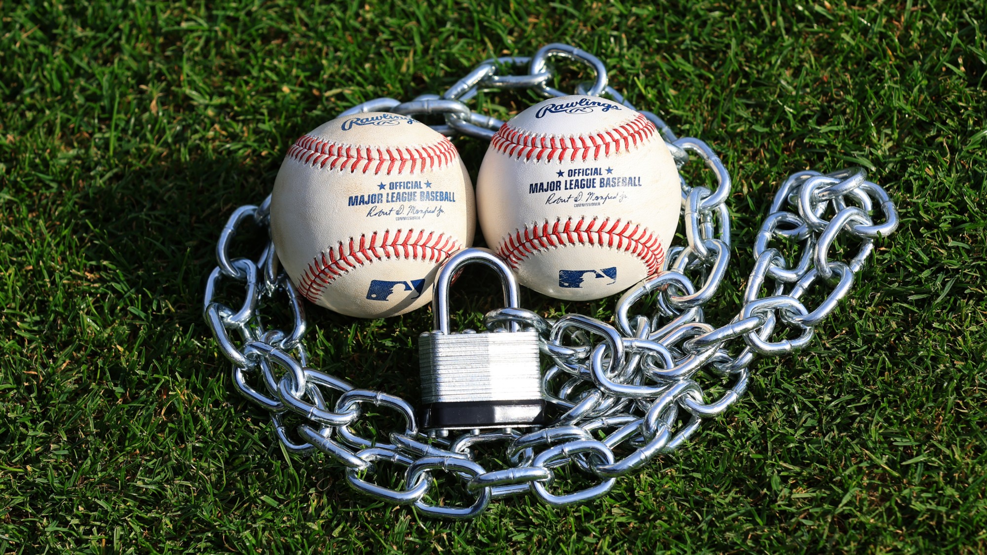 An image of baseballs surrounded by a padlock. 