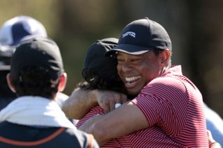 Tiger Woods hugs Charlie Woods after he makes a hole-in-one