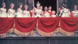 The newly crowned Queen Elizabeth II waves to the crowd from the balcony at Buckingham Palace