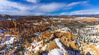 Snow covers the bright red hoodoos at Bryce Canyon National Park in Utah