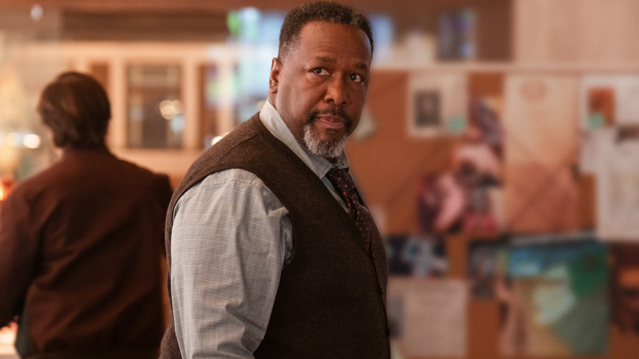 Wendell Pierce looks to his side while standing in the Daily Planet newsroom in Superman.