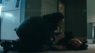 Devon kneeling next to an unconscious Mark in Severance season 2 episode 6