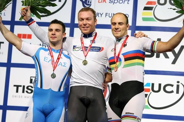 Chris Hoy (Great Britain) on the podium wearing the gold medal for the men's keirin flanked by bronze medalist Max Levy (Germany), right, and silver medallist Christos Volikakis (Greece), left.