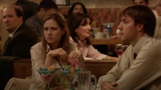Jim and Pam seated at a table with drinks in The Office