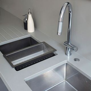 grey composite worktop with kitchen sink and steel tap