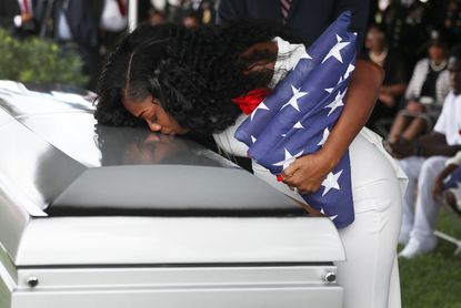 Myeshia Johnson kisses her husband's casket