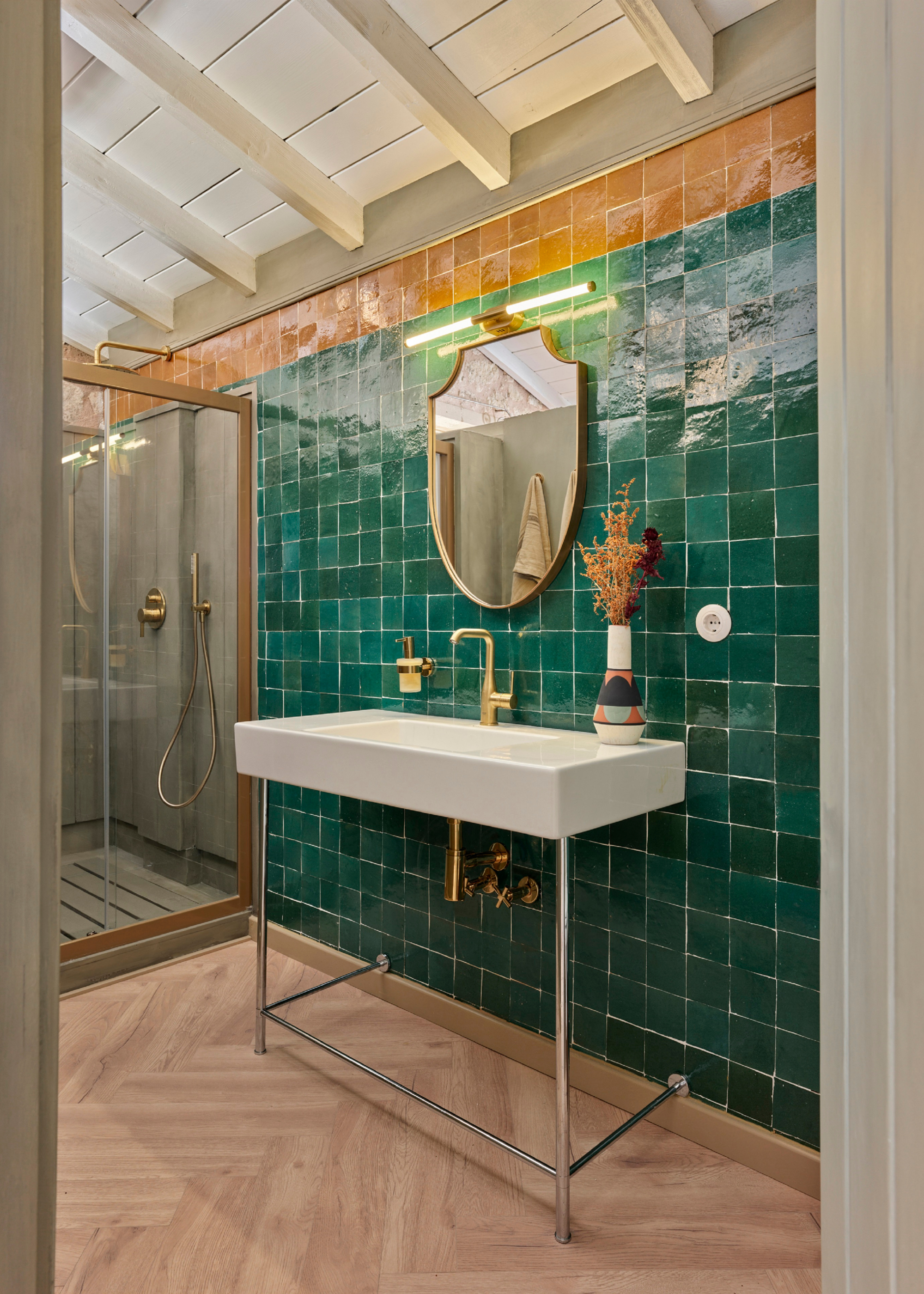 a green zellige tiled backsplash in a bathroom