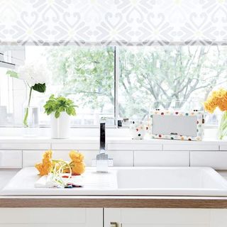 kitchen room with white tiles and window