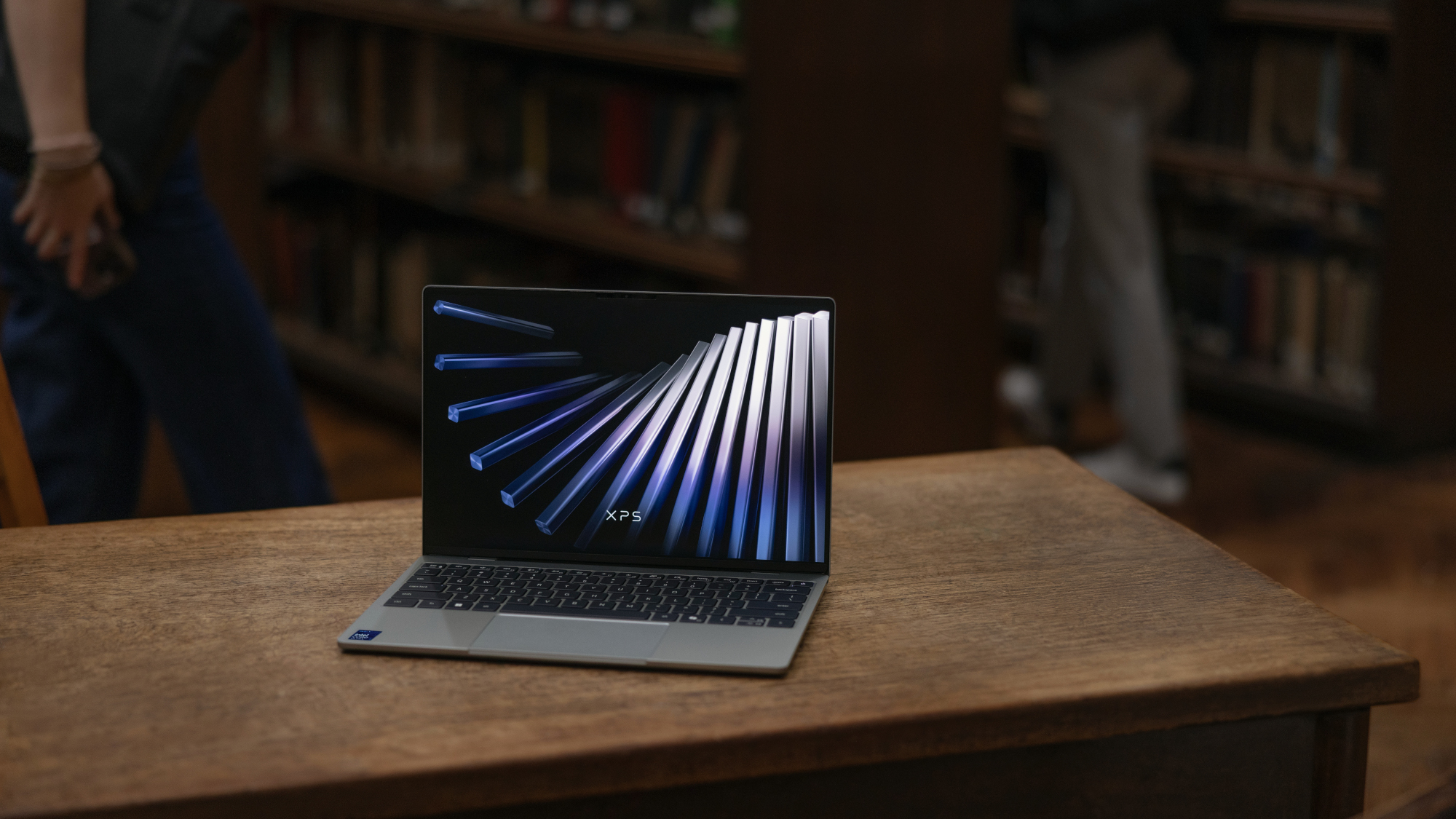 Dell XPS 13 laptop on a desk in a library