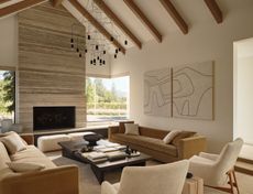 a modern living room with a stone fireplace