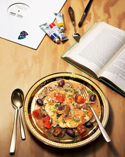 A plate of food on a table with an open book