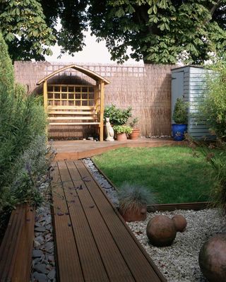 garden arbor ideas: wooden arbor at end of decked path