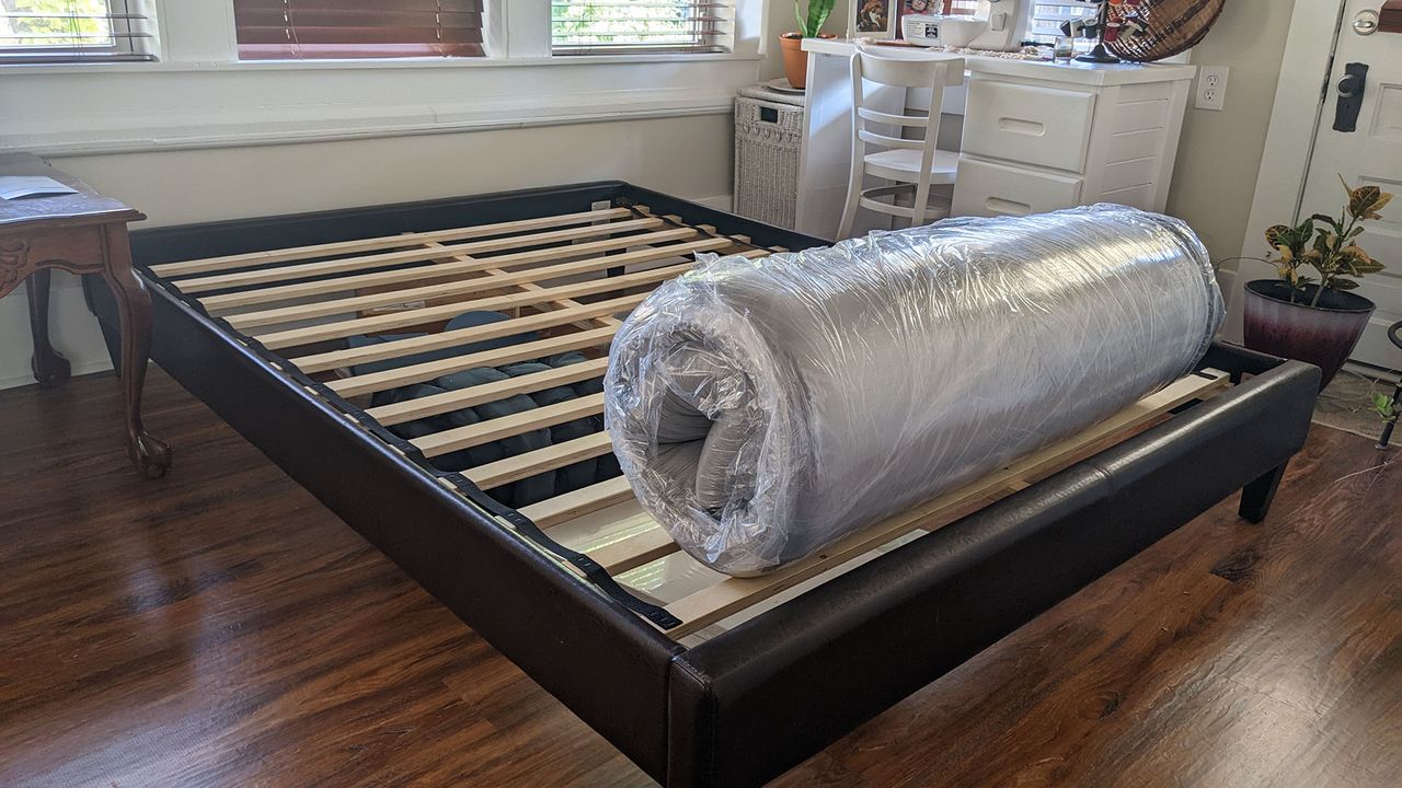 Bear Original mattress rolled and vacuum packed on a bed frame