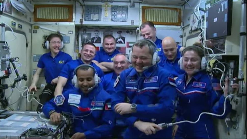 Crowded Space Station There Are 9 People from 4 Different Space