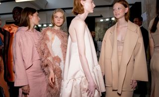 Models wear nude dresses, blazer and top
