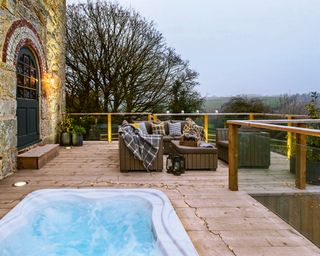 sunken hot tub in wooden deck in winter