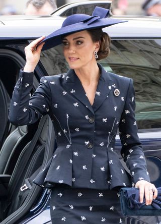Kate Middleton wearing a peplum-style suit.